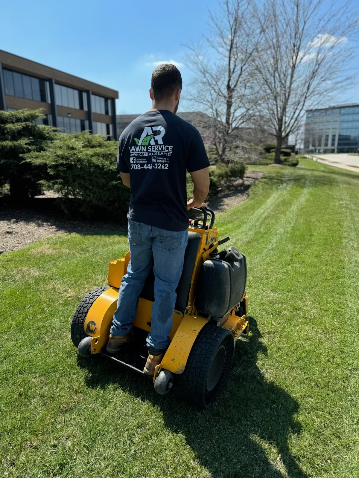 A.R Lawn Service team member mowing a commercial property